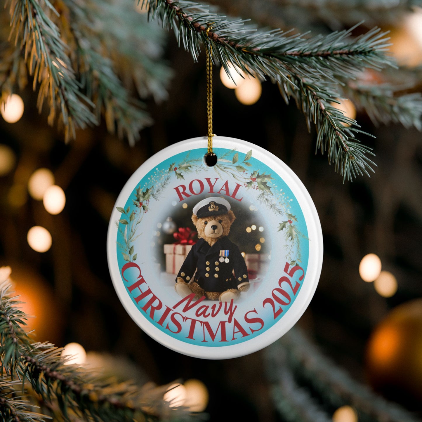 Royal Navy Christmas ornament 2025 featuring teddy bear in Royal Navy uniform with festive wreath and gold hanging string.
