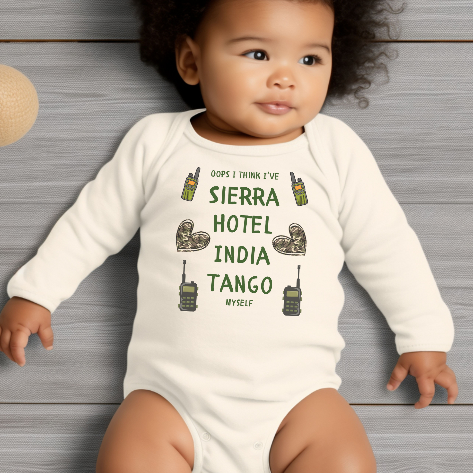 Funny military baby bodysuit with 'Oops I Think I Sierra Hotel India Tango Myself' design on the front and US flag in heart shape on the back, available in white, sizes Newborn to 18/24 months.